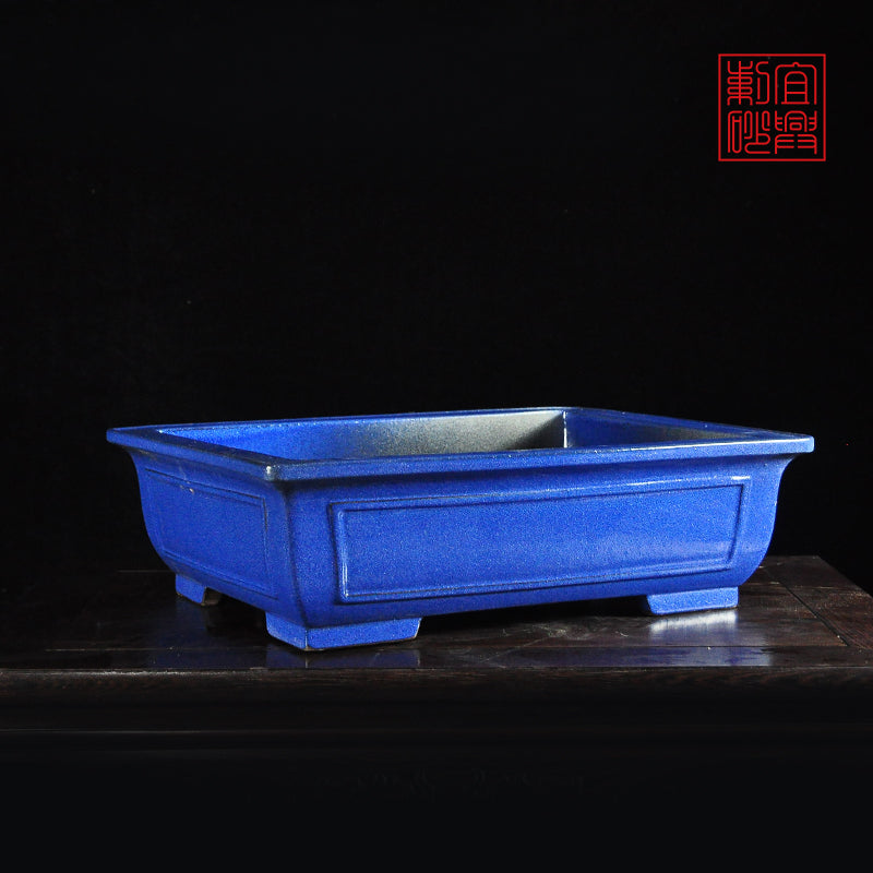 Dark blue rectangular glazed pot with open windows
